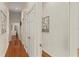 Bright hallway with wood flooring, white walls, and framed artwork at 1355 S Summerlin Ave, Orlando, FL 32806