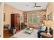 Cozy living room with wood-paneled walls, built-in shelving, and comfortable seating at 1355 S Summerlin Ave, Orlando, FL 32806