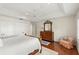 Bedroom features a tray ceiling, wood floors, an ornate mirror, and a cozy chair with decorative pillows at 1355 S Summerlin Ave, Orlando, FL 32806