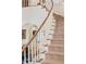 Elegant staircase featuring a curved wooden handrail and patterned carpet runner at 1355 S Summerlin Ave, Orlando, FL 32806