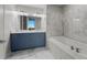 This bathroom has double sinks, a tub, and marble tile throughout at 150 E Robinson St # 2602, Orlando, FL 32801