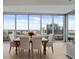 Elegant dining room with large windows showcasing stunning city views and seating for six at 150 E Robinson St # 2602, Orlando, FL 32801