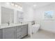 This bathroom boasts double sinks, quartz countertops, grey cabinets, and a soaking tub at 16146 Sw 24Th Court Rd, Ocala, FL 34473