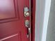 A stylish silver keypad and handle adorn a burgundy front door at 16146 Sw 24Th Court Rd, Ocala, FL 34473