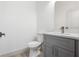 This bright powder room features a grey cabinet and a quartz countertop at 16146 Sw 24Th Court Rd, Ocala, FL 34473