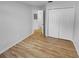 Bedroom featuring neutral paint tones, hardwood floors, and a double door closet at 1727 Winter Green Blvd, Winter Park, FL 32792