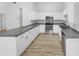 Well-lit kitchen featuring granite countertops, stainless steel appliances, and white cabinetry at 1727 Winter Green Blvd, Winter Park, FL 32792