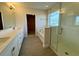 Bathroom with double vanity, glass-enclosed shower and separate tub at 18417 Oliver Twist Way, Winter Garden, FL 34787