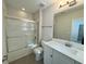 Modern bathroom with shower/tub combination, glass doors and quartz vanity at 18417 Oliver Twist Way, Winter Garden, FL 34787