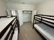 Shared bedroom with tile floors features two sets of bunkbeds and closet for storage at 18417 Oliver Twist Way, Winter Garden, FL 34787