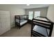 Shared bedroom features two sets of bunkbeds, tile floors, and good natural light at 18417 Oliver Twist Way, Winter Garden, FL 34787