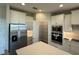 White kitchen featuring stainless steel appliances, a walk-in pantry and ample cabinet space at 18417 Oliver Twist Way, Winter Garden, FL 34787