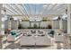 Inviting outdoor lounge area featuring modern furniture, a pergola, and decorative wall with plants at 18417 Oliver Twist Way, Winter Garden, FL 34787