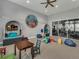 Community playroom with undersea themed decor, comfy seating and play structures at 18417 Oliver Twist Way, Winter Garden, FL 34787