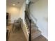 Carpeted staircase with iron spindles, connects to a living room at 18417 Oliver Twist Way, Winter Garden, FL 34787