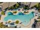 Aerial view of community pool and deck with sun loungers surrounded by tropical landscaping at 18417 Oliver Twist Way, Winter Garden, FL 34787