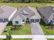 Stunning aerial view of a beautifully landscaped home with a charming blue accents and a brick driveway at 18955 Rawson St, Orlando, FL 32827