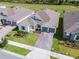 Charming aerial view of a beautifully landscaped home with a brick driveway and sidewalks at 18955 Rawson St, Orlando, FL 32827