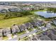 Aerial view of home in a residential neighborhood with a pond, green space and manicured streets at 18955 Rawson St, Orlando, FL 32827