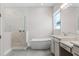 Modern bathroom with a freestanding tub, walk-in shower, and double vanity at 18955 Rawson St, Orlando, FL 32827