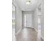 Inviting foyer with wood-look tile flooring leading to the front door with sidelight windows at 18955 Rawson St, Orlando, FL 32827