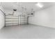 Spacious two-car garage with a durable, speckled floor coating, and two automatic door openers at 18955 Rawson St, Orlando, FL 32827