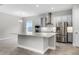 Contemporary kitchen featuring stainless steel appliances, a large island, and wood-look tile flooring at 18955 Rawson St, Orlando, FL 32827