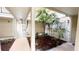 View of the open-air atrium with plenty of shade trees and a well-lit walkway at 1948 Lake Atriums Cir # 113, Orlando, FL 32839