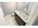 Bathroom features a dark vanity with granite countertop and tile floors at 1948 Lake Atriums Cir # 113, Orlando, FL 32839