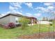 Landscaped backyard featuring a pergola and green lawn at 2032 Buckhanon Trl, Deland, FL 32720