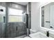 Modern bathroom featuring a glass-enclosed shower with gray tiling and a vanity with a backlit mirror at 2121 5Th Ave, Deland, FL 32724