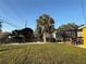 Fenced backyard featuring mature palm tree, pergola and ample space for outdoor activities at 2224 Patterson Ave, Orlando, FL 32811