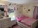 Bedroom with pink bedding and decorations and a white dresser at 2224 Patterson Ave, Orlando, FL 32811