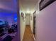 Hallway with wood flooring, framed art, and view into the living room with an aquarium at 2224 Patterson Ave, Orlando, FL 32811