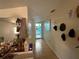 Hallway featuring neutral walls and tiled floors, with vanity and view into bathroom at 2224 Patterson Ave, Orlando, FL 32811