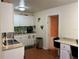 Bright kitchen with white cabinetry, laminate countertops, and dining space at 2224 Patterson Ave, Orlando, FL 32811