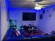 Living room with blue LED lighting, fish tank, and a large sectional couch at 2224 Patterson Ave, Orlando, FL 32811