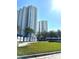 Exterior view of high-rise condos with 'Welcome' sign and landscaping on a sunny day at 231 Riverside Dr # 1510-1, Daytona Beach, FL 32117