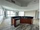 Contemporary kitchen with stainless steel dishwasher, wood cabinetry, and bar-style seating at 231 Riverside Dr # 1510-1, Daytona Beach, FL 32117