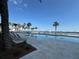 Resort style pool with lounge chairs, palm trees, and blue skies at 231 Riverside Dr # 1510-1, Daytona Beach, FL 32117