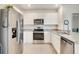 Well-lit kitchen featuring stainless steel appliances, white cabinets, and granite countertops at 2321 Tay Wes Dr, St Cloud, FL 34771