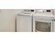 Modern laundry room featuring a white washer and dryer set at 2321 Tay Wes Dr, St Cloud, FL 34771