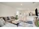 A cozy living room and dining area, with white tile and grey furniture at 2321 Tay Wes Dr, St Cloud, FL 34771