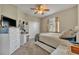 Cozy bedroom with carpet flooring, closet, ceiling fan, and a window providing natural light at 248 Isle Of Sky Cir, Orlando, FL 32828