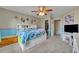 Colorful bedroom with a ceiling fan, a bed with drawers and a storage unit, and a closet at 248 Isle Of Sky Cir, Orlando, FL 32828