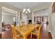 Dining area with wood floors and views into the living room and office at 248 Isle Of Sky Cir, Orlando, FL 32828