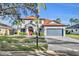 Charming two-story home with a red front door, a manicured lawn, and a two car garage at 248 Isle Of Sky Cir, Orlando, FL 32828