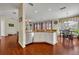 Bright kitchen with stainless steel appliances, granite counters, white cabinetry and an adjacent dining area at 248 Isle Of Sky Cir, Orlando, FL 32828