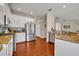 Modern kitchen with stainless steel appliances, granite countertops, white cabinets, and wood flooring at 248 Isle Of Sky Cir, Orlando, FL 32828