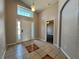 Bright foyer with high ceilings, decorative window above front door and tile floor with rug accents at 2932 Trema Ave, Winter Haven, FL 33881